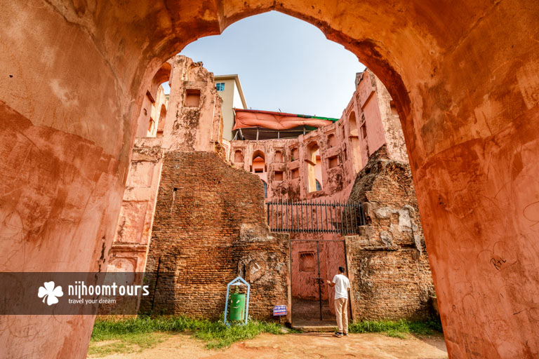 Photo of a man looking at a secret tunnel in Lalbagh Fort
